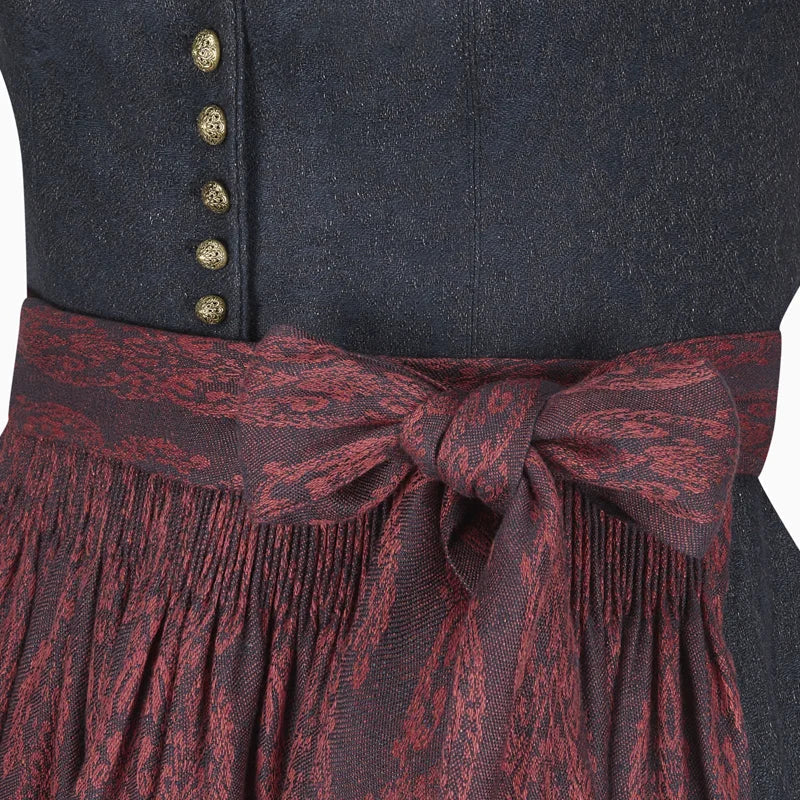 Close-up of a dark blue garment with gold buttons and a red patterned belt.