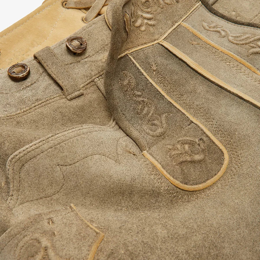 Close-up of beige leather goods with branding details