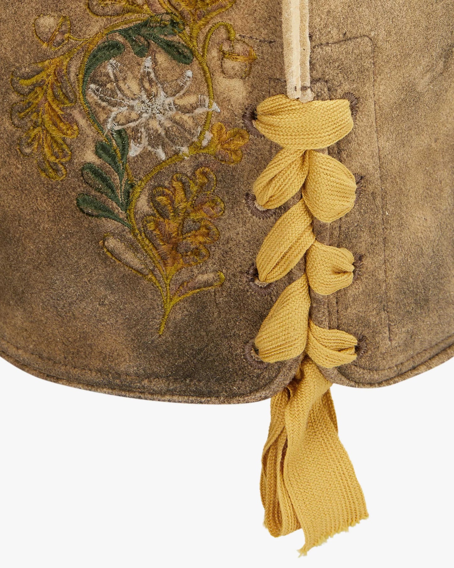 Brown fabric with embroidered floral design and yellow tassels on a white background