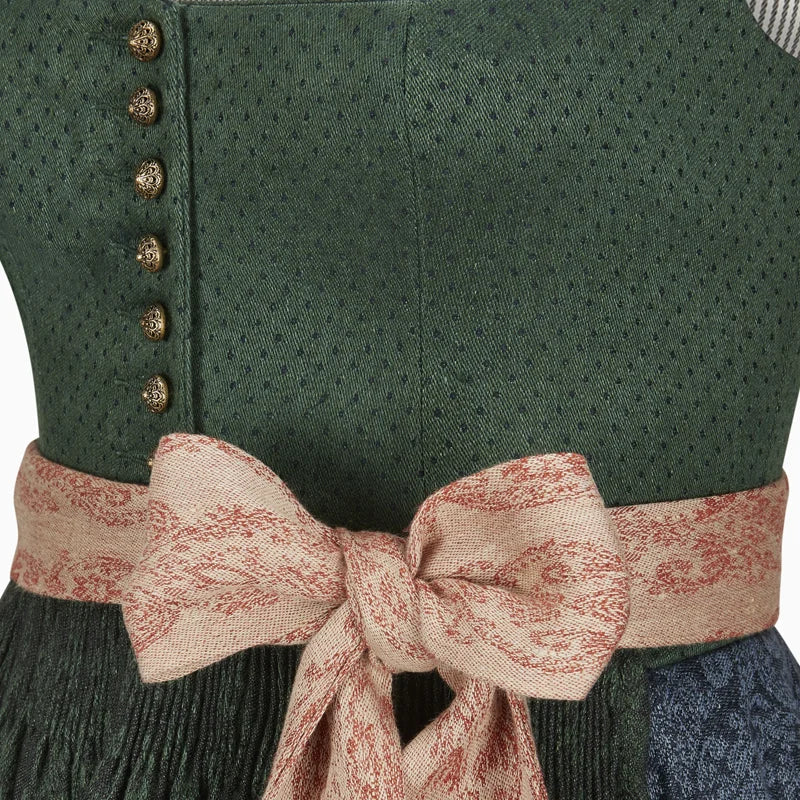 Close-up of a green dress with a patterned belt and buttons.