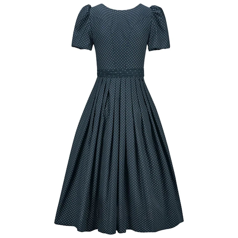 Navy polka dot dress on a white background
