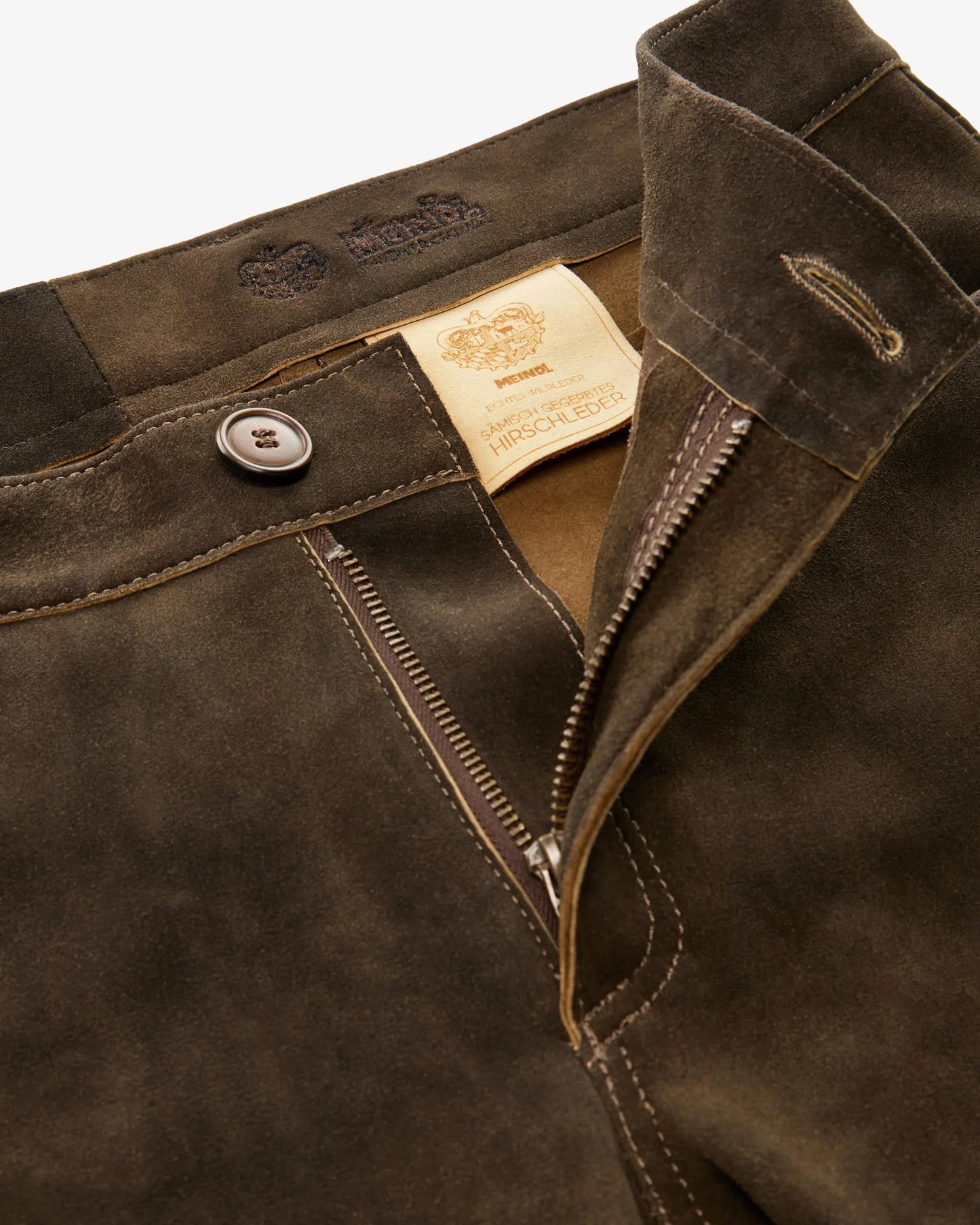 Close-up of a brown jacket with a brand label on a white background