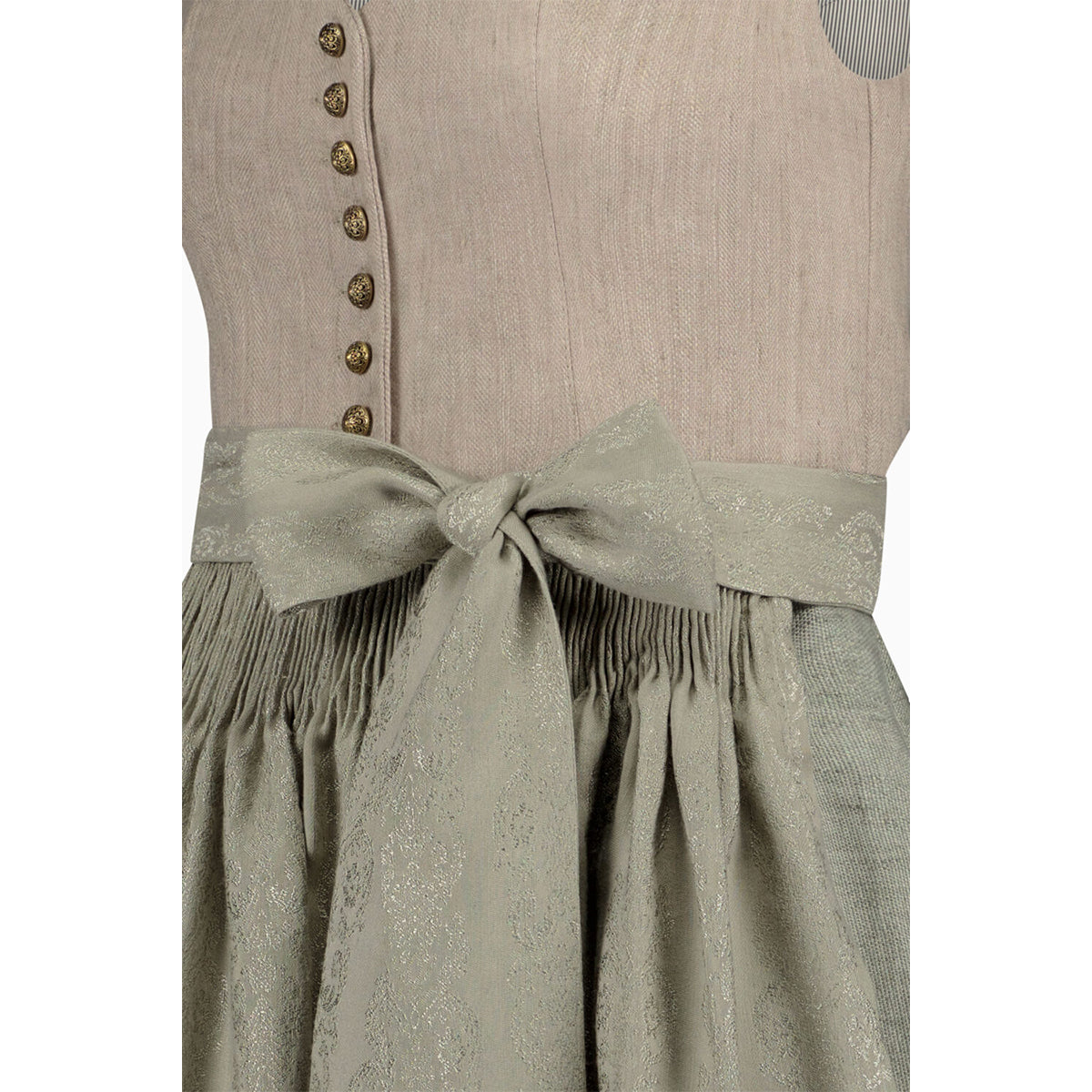 Traditional Bavarian dirndl with a beige bodice and green skirt on a white background