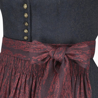 Close-up of a dark blue garment with gold buttons and a red patterned belt.