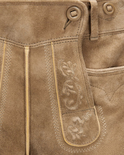 Close-up of brown leather pants with stitching details