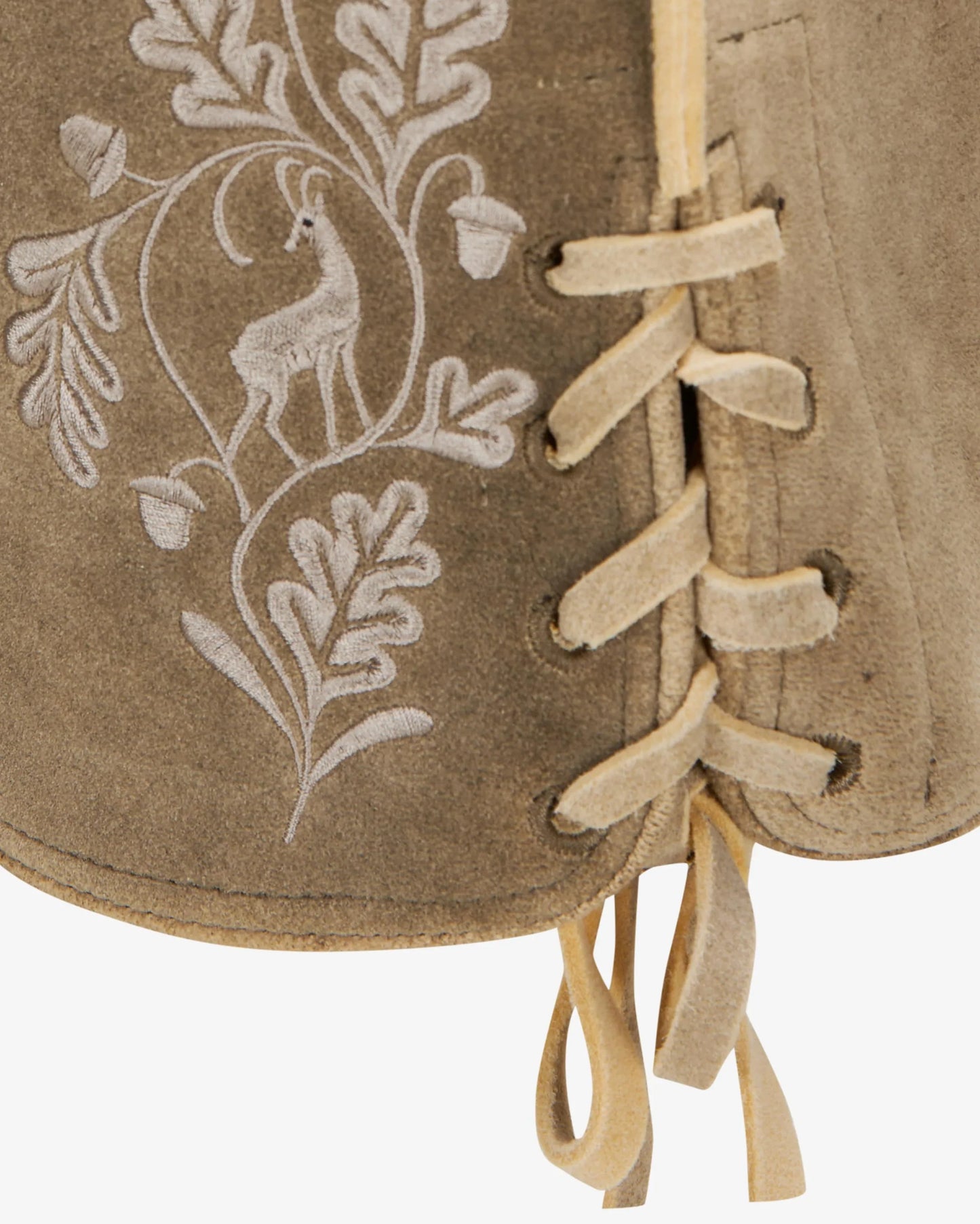 Close-up of a brown leather-bound book with white embroidered design on a white background