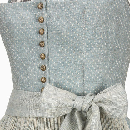 Close-up of a light blue dress with buttons and a bow detail.