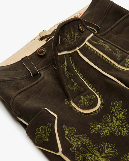Brown pants with green embroidery on a white background