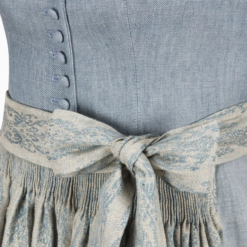 Close-up of a blue dirndl dress with a patterned belt