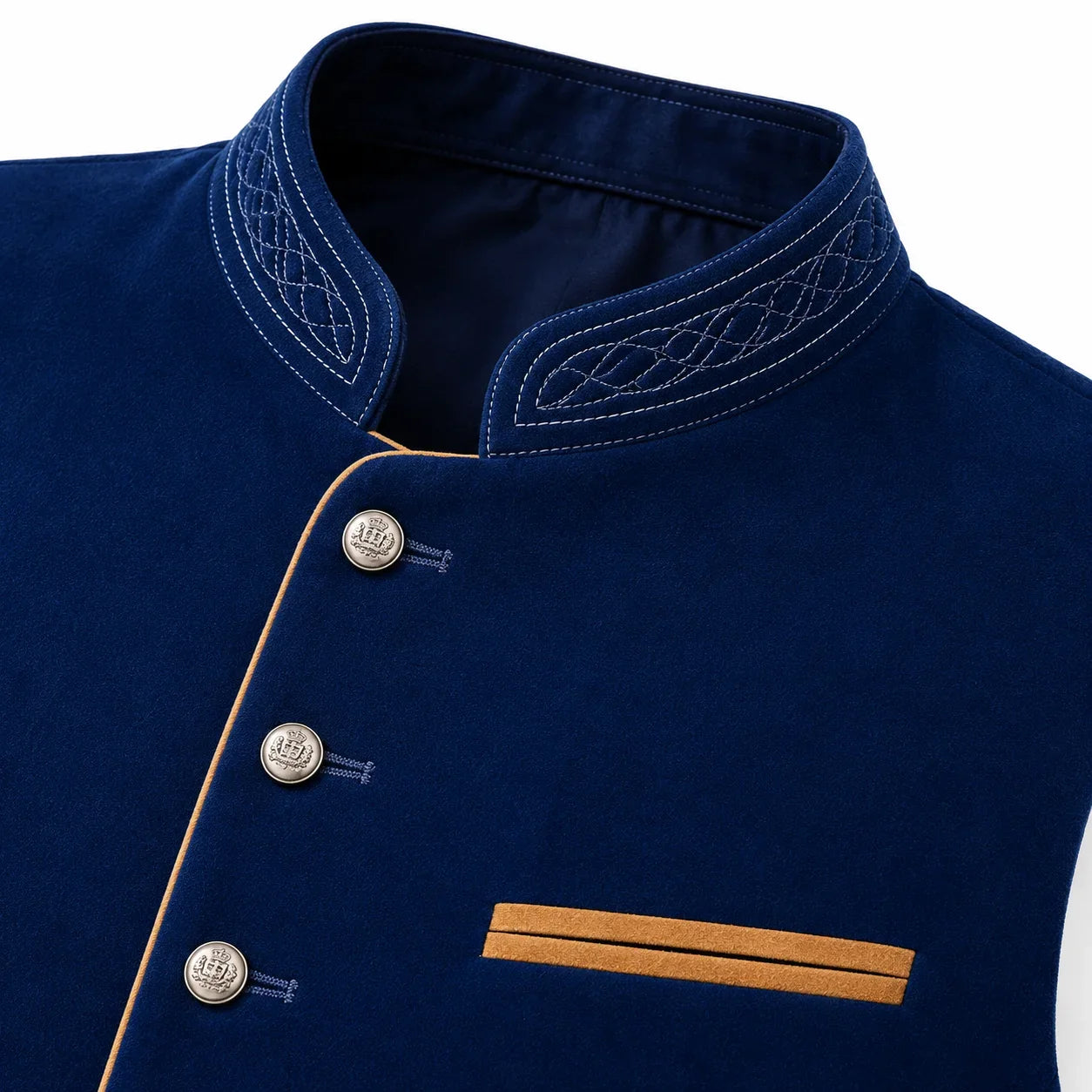 Close-up of a navy blue traditional-style jacket or vest with a mandarin collar, decorative white embroidery, silver buttons, and contrasting tan trim.