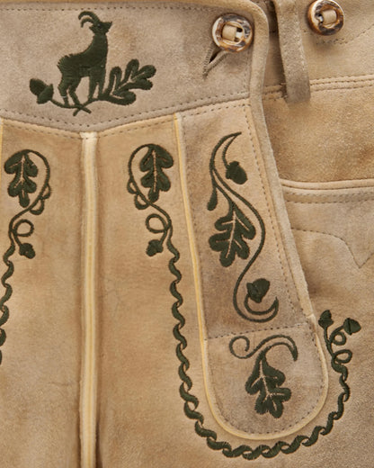 Close-up of beige leather with green embroidery and button details