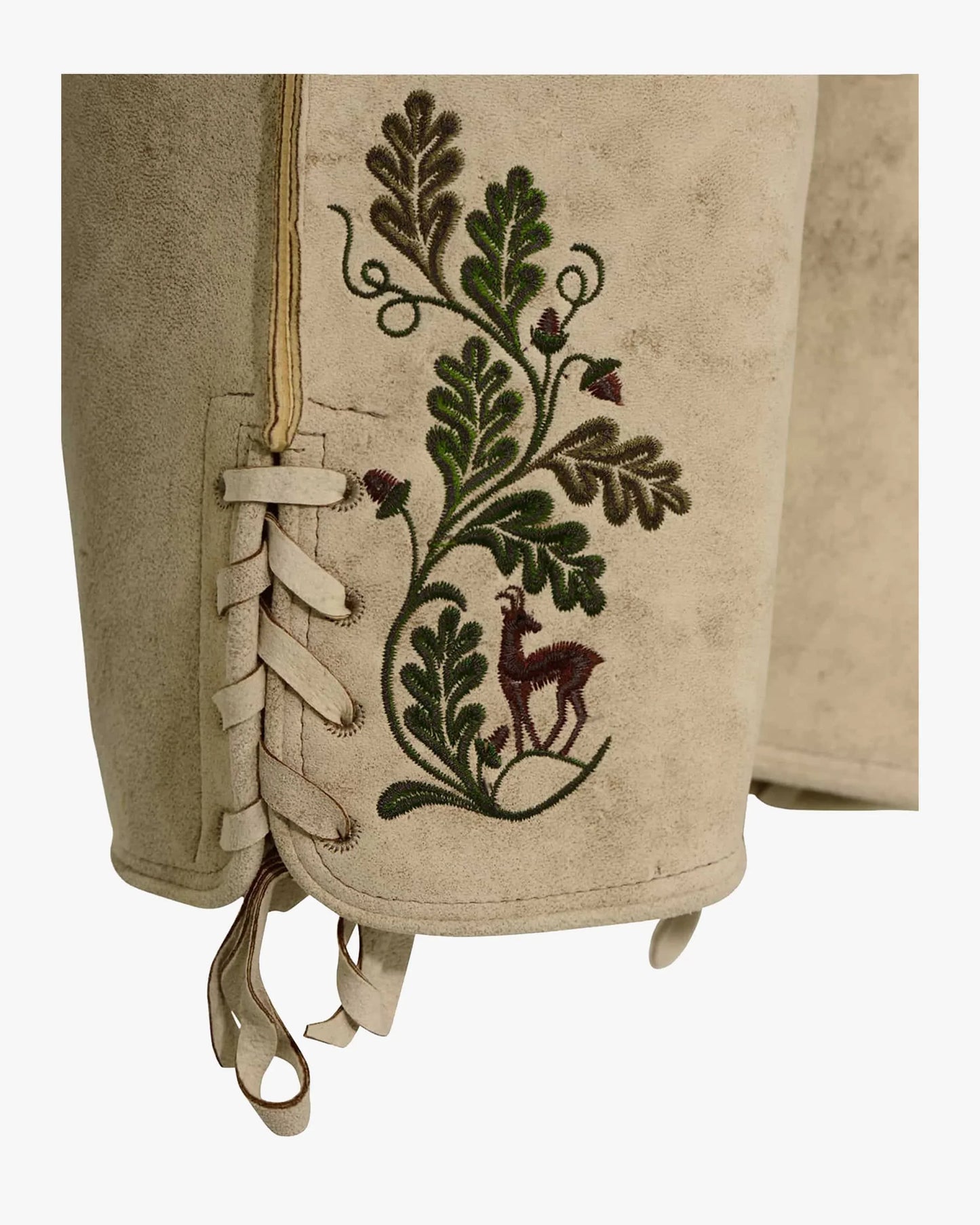 Embroidered fabric with a deer and leaf design on a beige background
