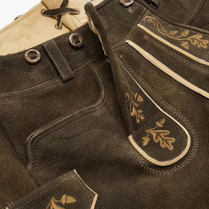 Close-up of brown leather boots with decorative stitching and buttons.
