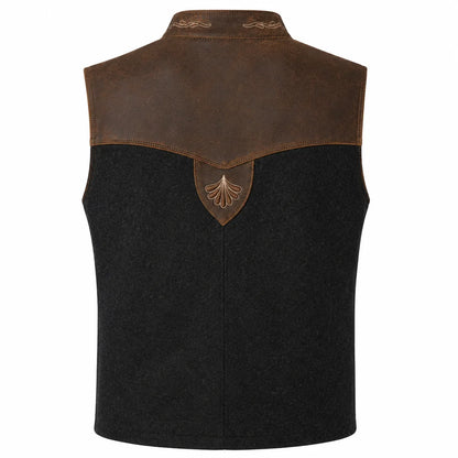 A sleeveless western-style vest with a black wool-like body, a brown leather yoke, and a matching brown shield-shaped patch with an engraved leaf design at the center back.