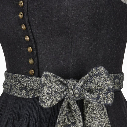 Black dress with gold buttons and a patterned belt on a plain background