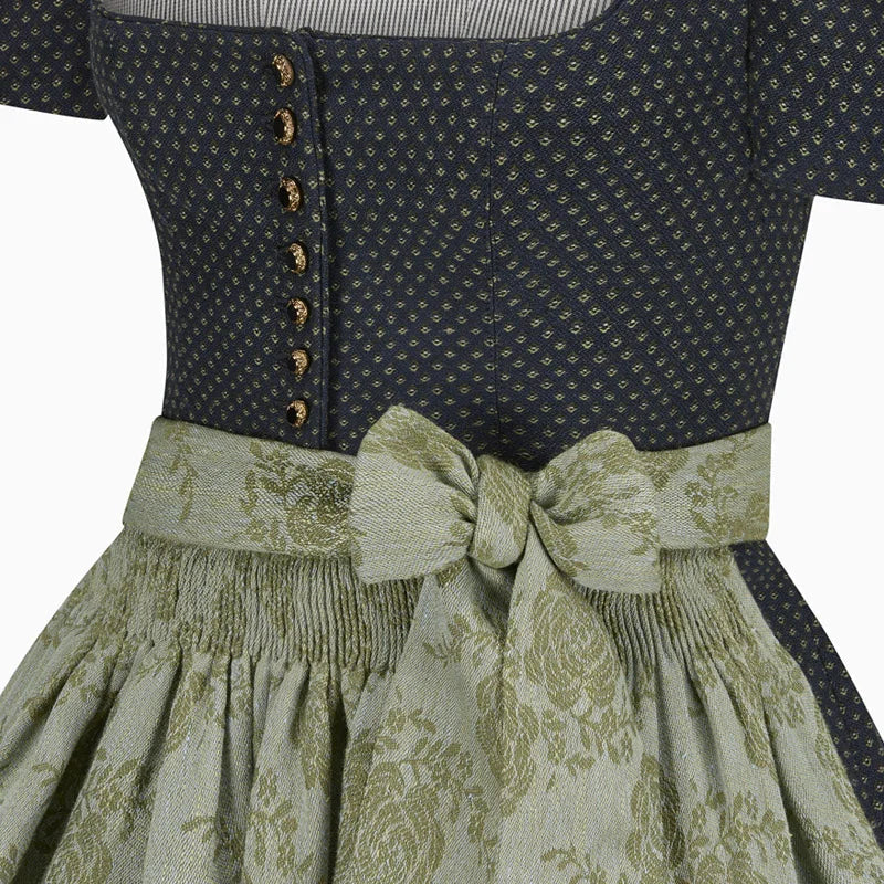 Close-up of a dress with a patterned top and floral skirt on a white background