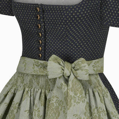 Close-up of a dress with a patterned top and floral skirt on a white background
