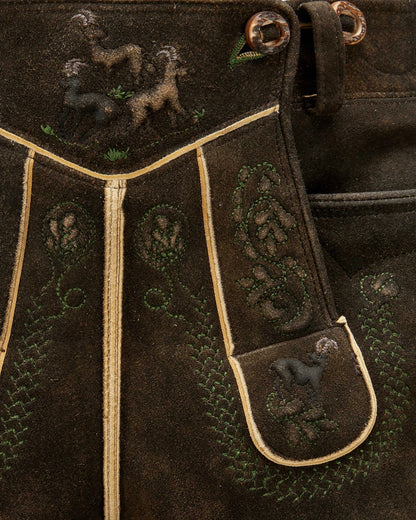 Close-up of a dark brown leather bag with embroidered designs featuring animals.