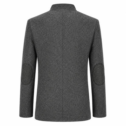 A dark gray textured wool-blend blazer shown from the back, featuring circular patchwork elbow patches on the sleeves and a clean collar.