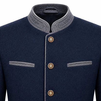 A close-up of a men's traditional-style jacket in dark navy blue with contrasting gray trim on the stand collar, button placket, and chest pockets, featuring three gold-tone buttons.