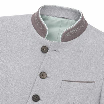 Close-up of a light gray textured jacket with a mandarin collar, featuring a contrasting brownish-gray inner collar with white embroidery, a pale green lining, and three dark buttons.