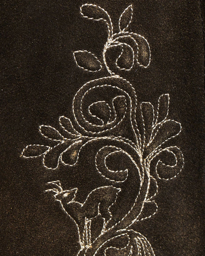 Decorative floral embroidery on a dark fabric background
