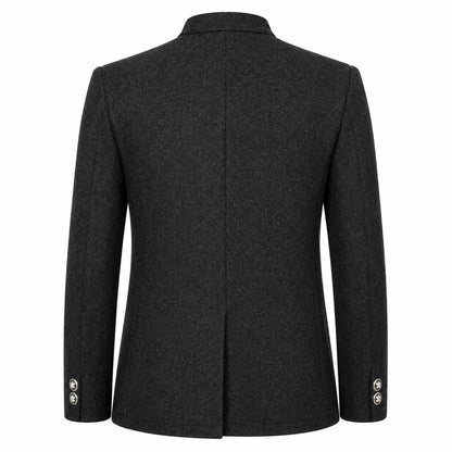 A dark charcoal gray wool-blend blazer shown from the back, featuring a structured collar, a central seam, and button details on the cuffs, set against a plain white background.