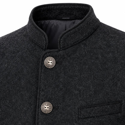 Close-up of a dark charcoal gray textured wool jacket with a mandarin collar, decorative embroidered details on the collar, and two round silver-tone buttons with a central owl emblem.