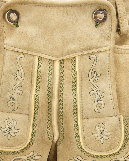 Close-up of beige fabric with intricate green embroidery