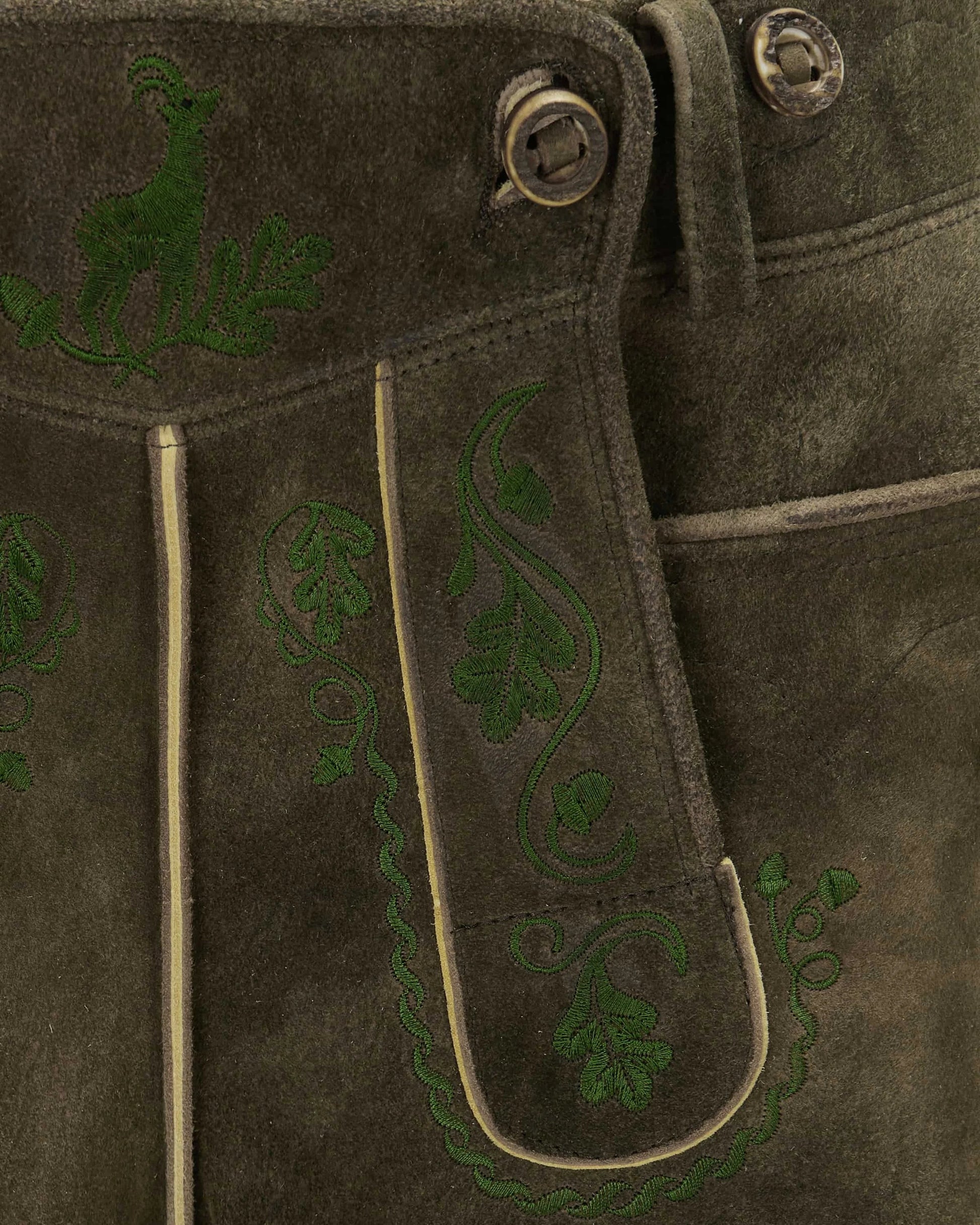 Brown leather jacket with green embroidered designs on a dark background