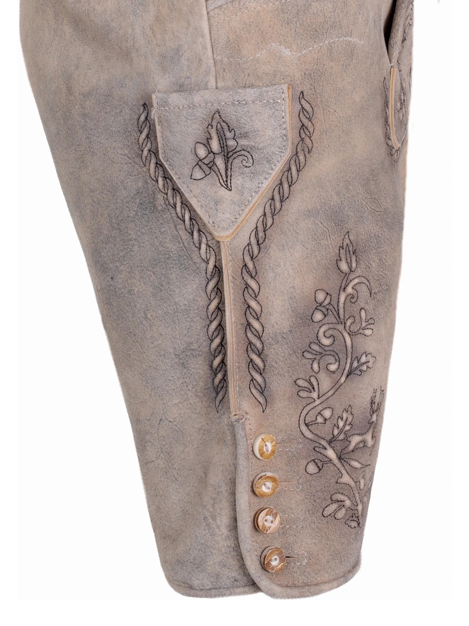 Close-up of a brown leather boot with intricate designs and decorative buttons on a white background