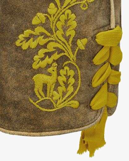 Embroidered fabric with yellow floral and deer design on a brown background