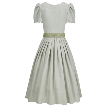 Light gray dress with a green belt on a white background