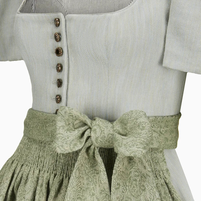 Light gray top with button details and a green textured skirt on a white background