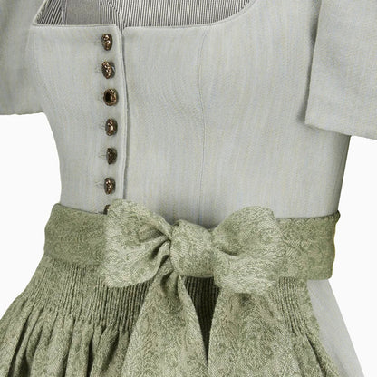 Light gray top with button details and a green textured skirt on a white background