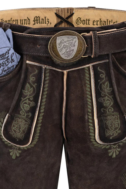 Brown leather pants with intricate embroidery and a decorative belt buckle.