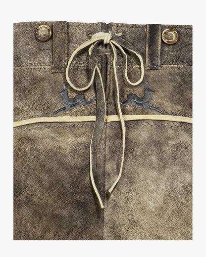 Brown leather bag with drawstring and embroidered designs on a white background