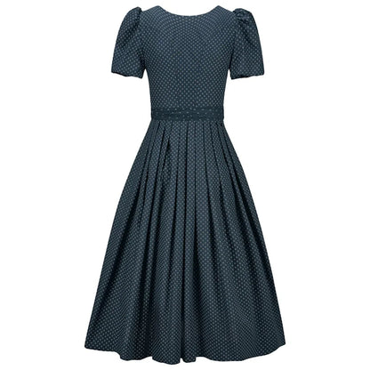 Navy polka dot dress on a white background