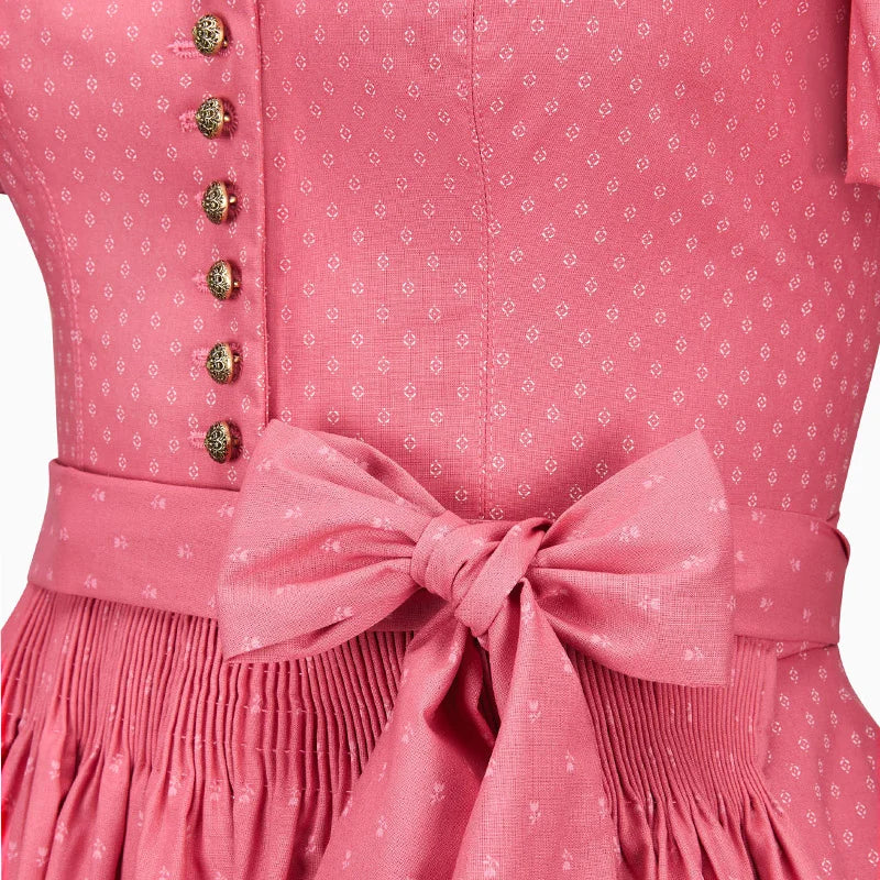 Close-up of a pink dress with a bow detail and floral pattern.