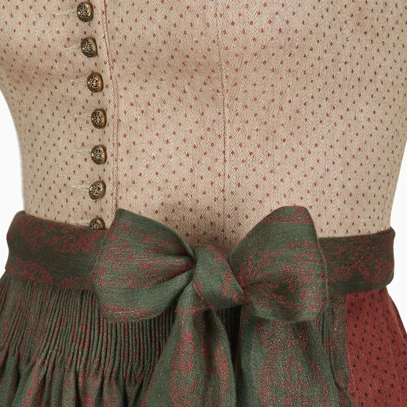 Close-up of a vintage-style dress with a green sash and buttoned bodice.