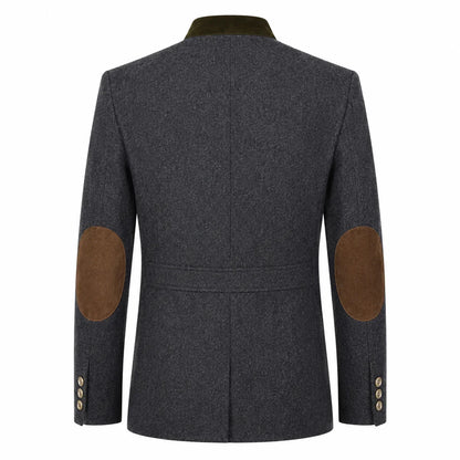 A dark gray textured wool-blend blazer shown from the back, featuring brown suede elbow patches and a contrasting dark olive green collar.