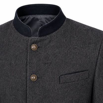 Close-up of a dark gray textured jacket with a black mandarin collar, bronze buttons, and a welt pocket on the chest.