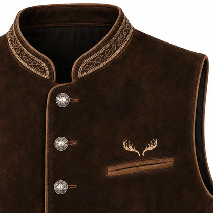 Close-up of a dark brown suede vest with ornate gold embroidered trim on the collar, three decorative silver buttons, and an embroidered deer antler motif on the chest pocket.