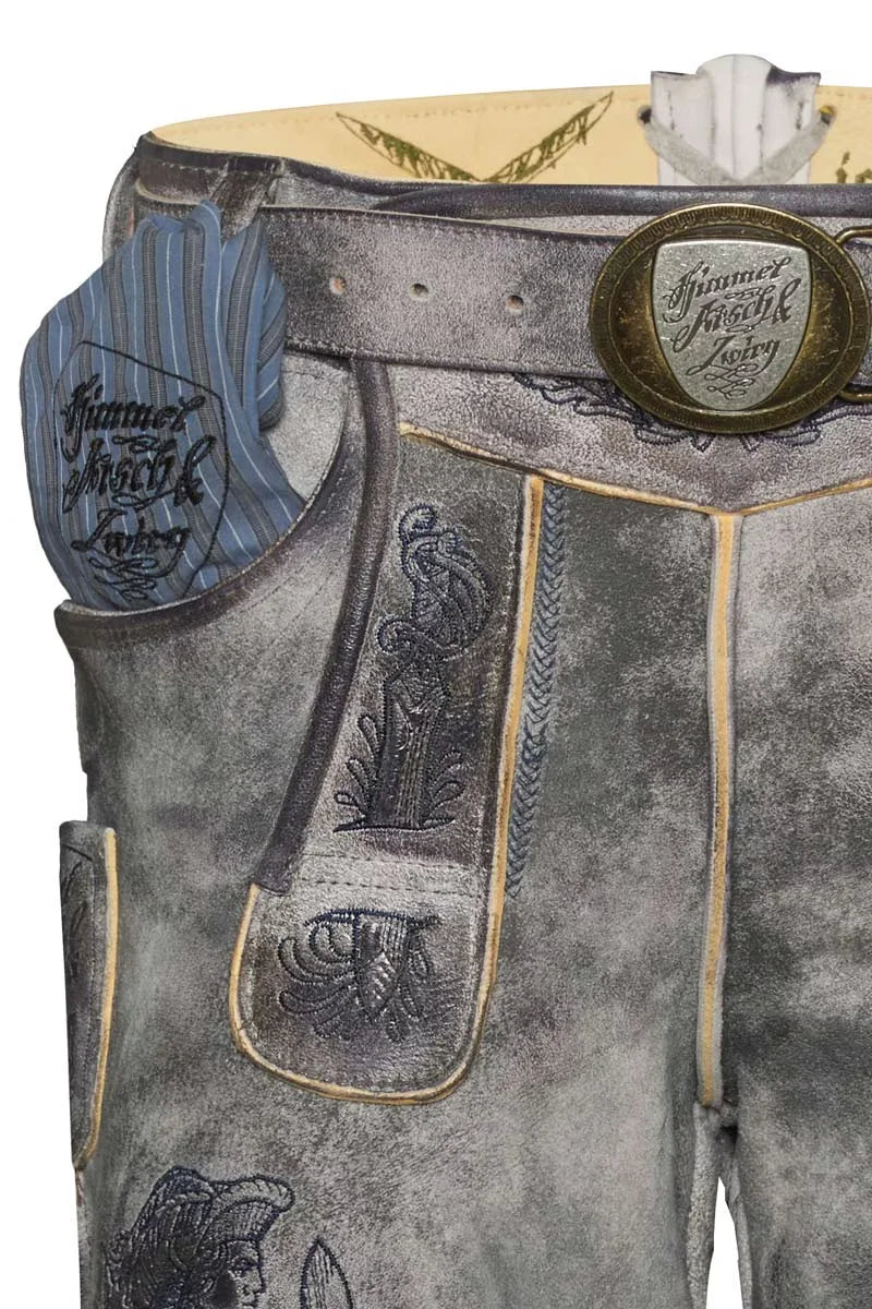 Close-up of traditional leather pants with embroidered details and a brand logo.
