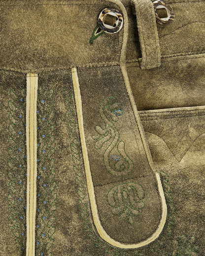 Close-up of a brown leather belt with decorative stitching on a textured fabric background