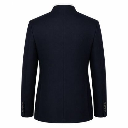 A dark navy blue blazer shown from the back, featuring a structured collar, long sleeves, and a central seam, photographed against a solid white background.