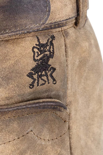 Close-up of a brown leather boot with a black embroidered design on a white background