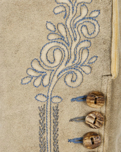 Close-up of a decorative pattern on a fabric with wooden beads.