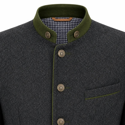 Close-up of a dark gray wool jacket with an olive green mandarin collar, matching green piping, and bronze-colored buttons, showing a checkered lining inside the collar.