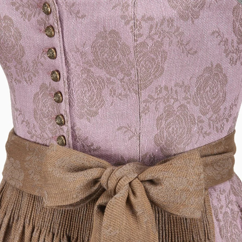 Close-up of a traditional outfit with a patterned top and brown belt.